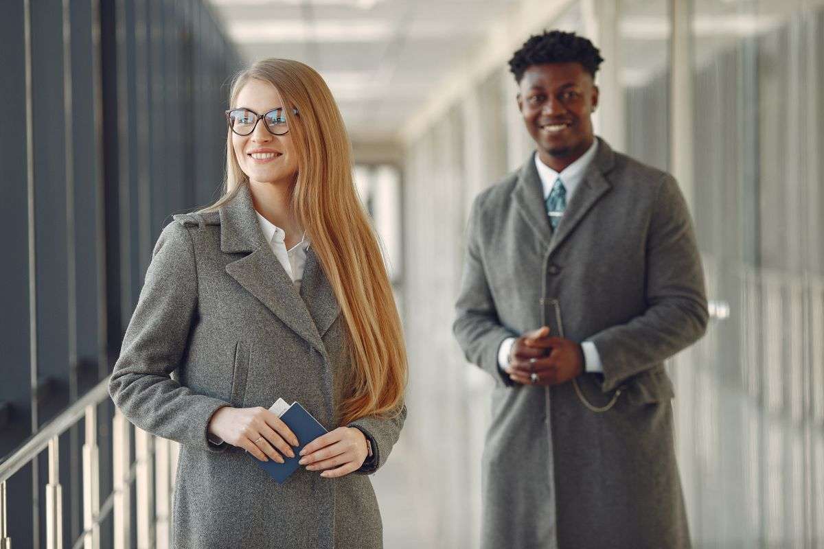 Business travelers with passports at an airport, representing the executive travel risk behind kidnap and ransom insurance