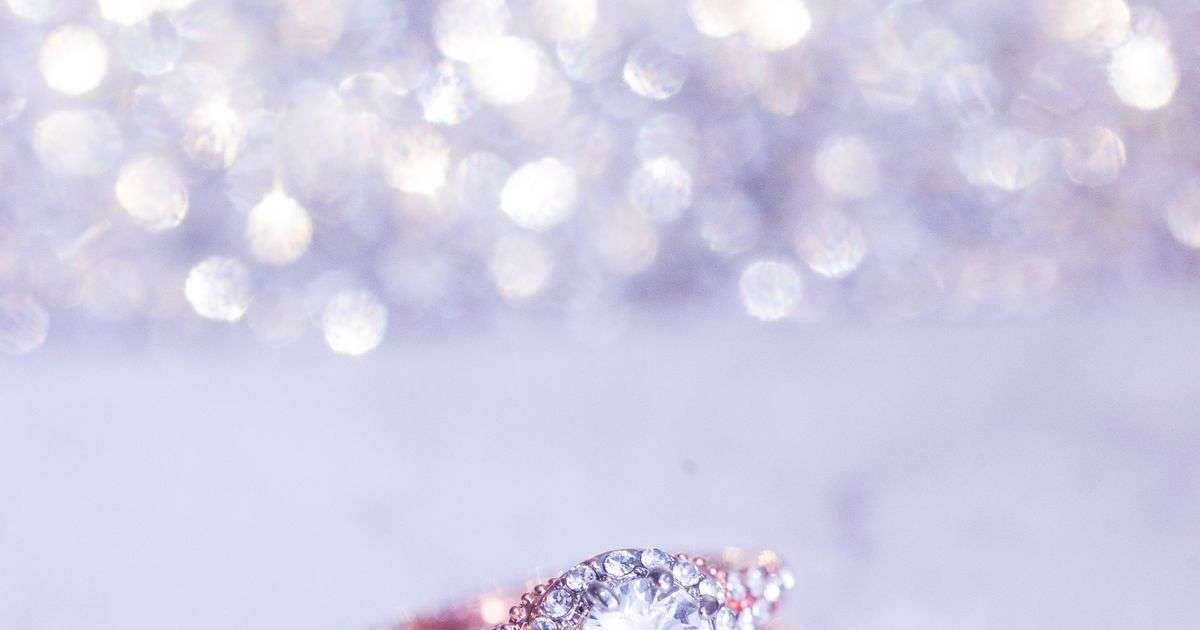 Sparkling diamond engagement ring on a marble surface, representing engagement ring and jewelry insurance