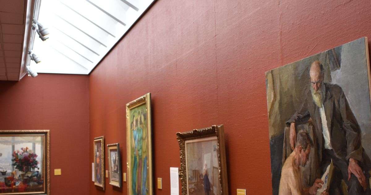 Art gallery with red walls and framed paintings, representing fine art insurance for collectors